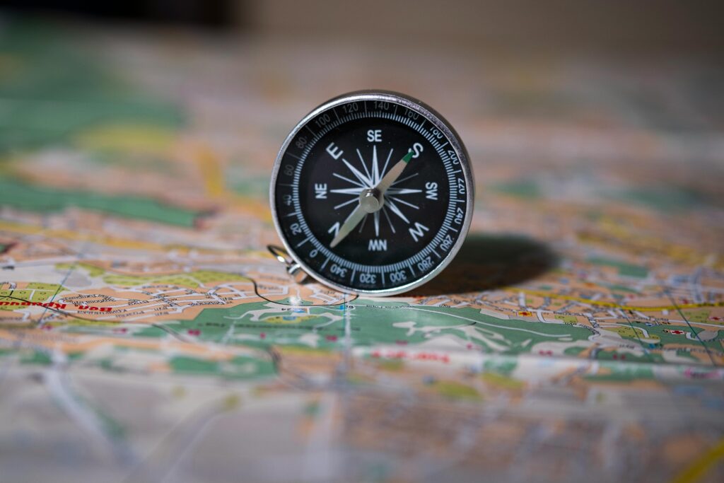 Black compass on detailed map symbolizing navigation and exploration.
