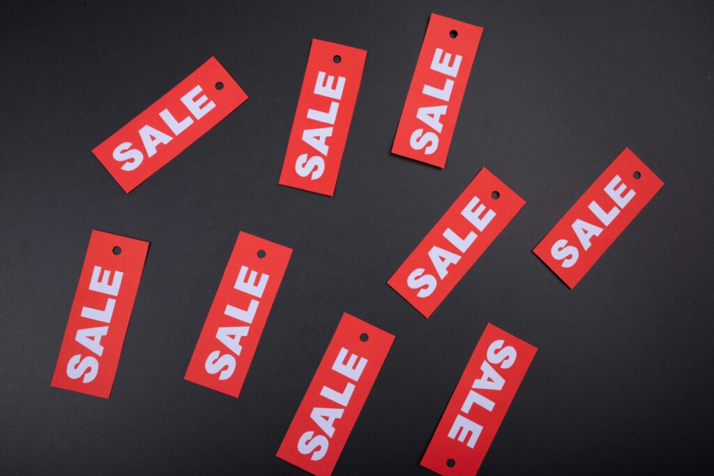 Red sale tags on a black background. Ideal for marketing and promotional use.